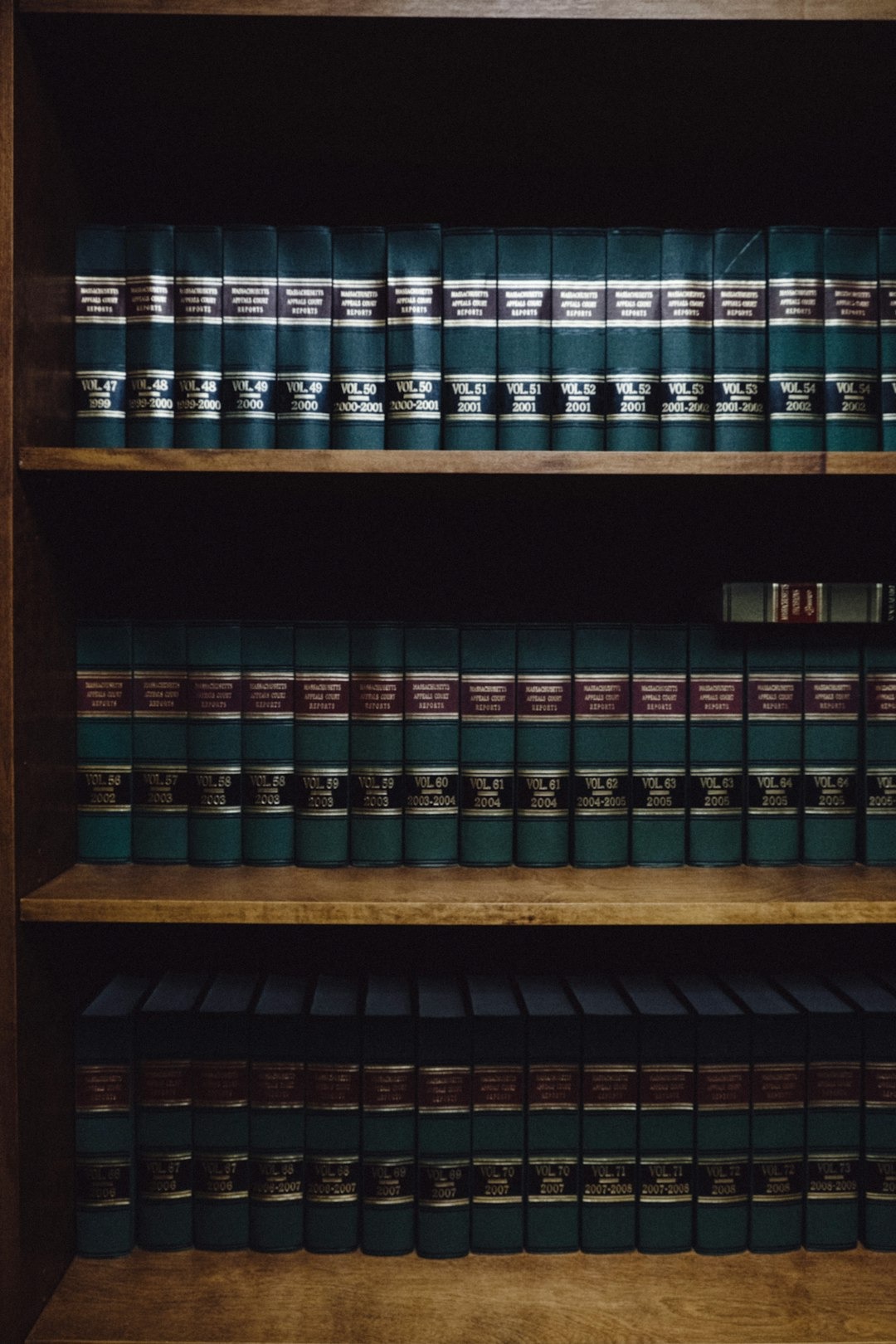 Wooden bookshelves filled with rows of law books.